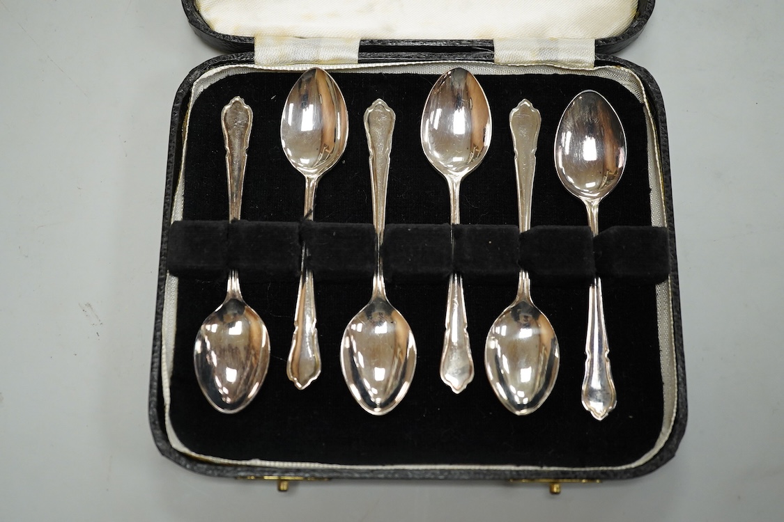 A Portuguese white metal 916 standard circular box and cover, retailed by Joalharia Do Carmo, diameter 94mm, together with cased set of six silver plated coffee spoons, a cased silver teaspoons, a Victorian silver christ